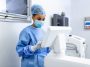 Female surgeon with surgical mask at operating room using 3d image guided surgery machine Best Cancer Treatment India